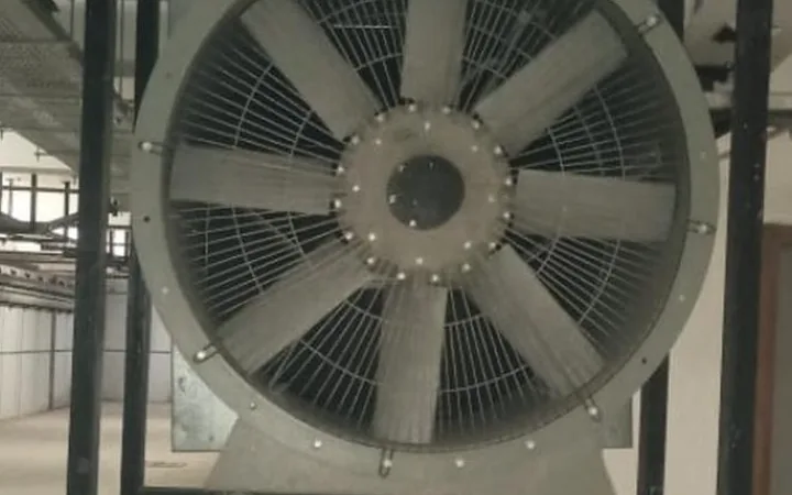 Large axial exhaust fan mounted on a wall