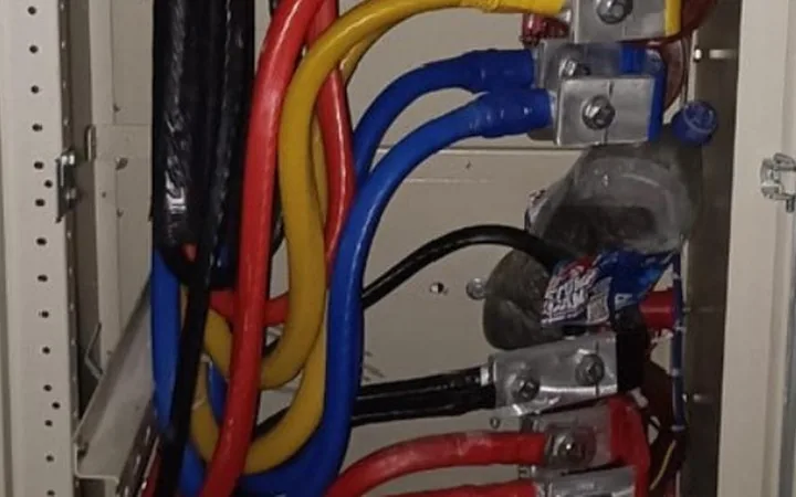 Colour-coded LT cables terminated inside an electrical panel